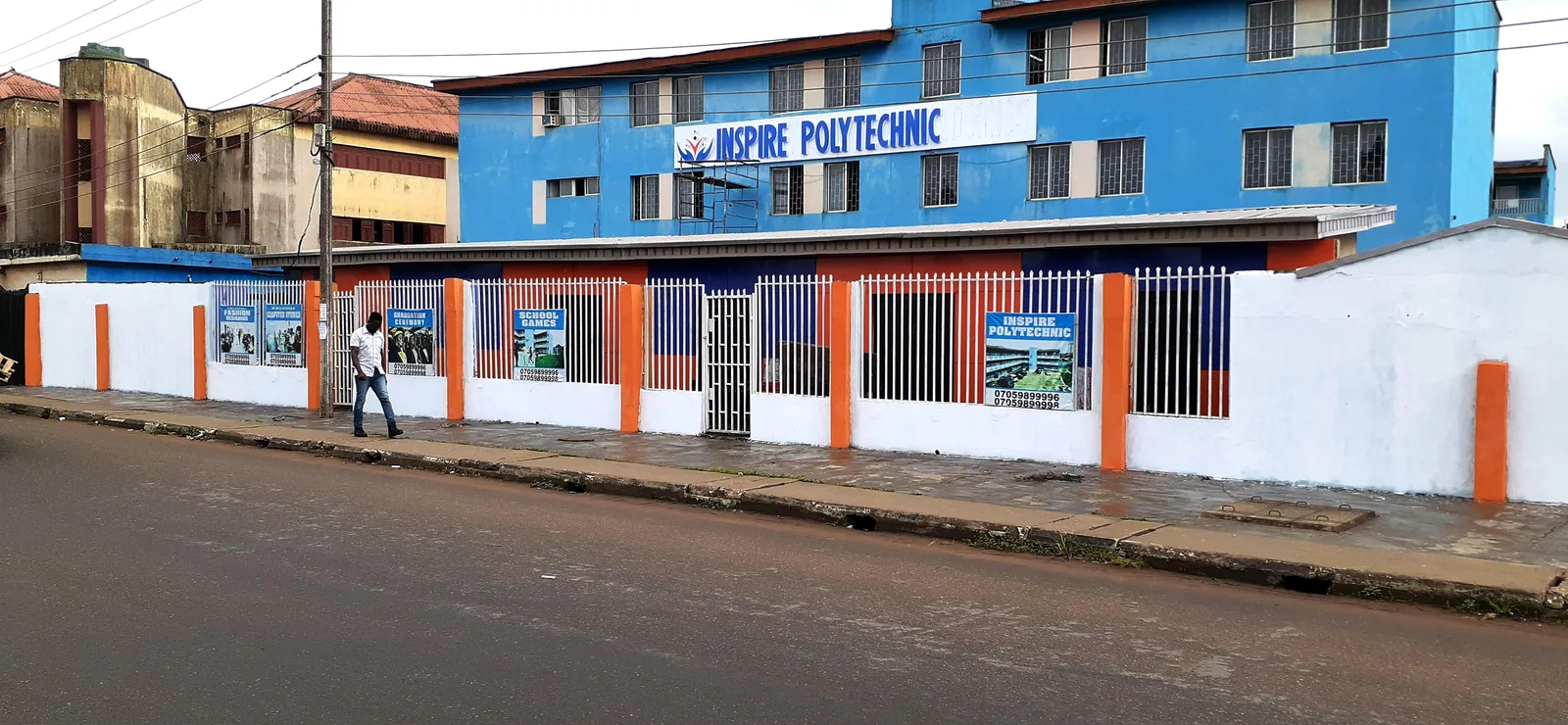 Blue and orange Inspire Polytechnic building with the institution’s name above the entrance