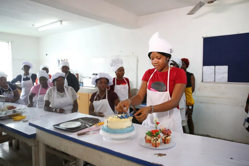 Catering students working on a cake